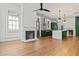 Bright living room featuring a fireplace, modern ceiling fan, and open access to the kitchen at 19 Smith St # B, Charleston, SC 29401