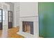 Living room with decorative fireplace, hardwood floors, and bold geometric wallpaper at 19 Smith St # B, Charleston, SC 29401