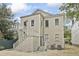 Rear exterior showing a two-story home with stairwell entrance and gravel yard at 19 Smith St # B, Charleston, SC 29401