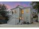 Rear exterior view of a two-story home with outdoor stairwell and subtle lighting at 19 Smith St # B, Charleston, SC 29401