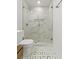Bathroom featuring a glass-enclosed shower and modern fixtures, with unique flooring at 19 Smith St # C, Charleston, SC 29401
