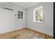 Well-lit bedroom with hardwood floors, white walls, and updated fixtures at 19 Smith St # C, Charleston, SC 29401
