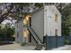 Exterior evening view featuring stucco, stairs, updated windows, lighting, and manicured landscaping around the perimeter at 19 Smith St # C, Charleston, SC 29401