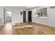 Sunlit living room featuring hardwood flooring, light walls, and direct access to the outside at 19 Smith St # C, Charleston, SC 29401