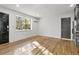 Inviting living room with hardwood floors, natural light from a large window, and neutral colored walls at 19 Smith St # C, Charleston, SC 29401