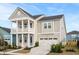 Charming two-story home with a welcoming front porch, manicured landscaping, and an attached two-car garage at 190 Steepbrook Dr, Summerville, SC 29486