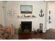 Living room with nautical decor, fireplace, and decorative compass over the mantle at 1928 Chatelain Way, Mount Pleasant, SC 29464