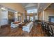 Bright community lounge with high ceilings, fireplace, piano, and seating areas on hardwood floors at 1928 Chatelain Way, Mount Pleasant, SC 29464