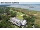 Aerial view of a river course, and clubhouse surrounded by lush greenery, and the Kiawah River at 200 Belted Kingfisher Rd, Kiawah Island, SC 29455