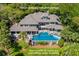 Stunning aerial view of a house showcasing a beautiful pool and lush greenery at 200 Belted Kingfisher Rd, Kiawah Island, SC 29455