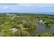 Aerial view of a home near the water, surrounded by lush landscaping and showcasing coastal charm at 200 Belted Kingfisher Rd, Kiawah Island, SC 29455