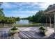 Backyard deck featuring serene lake views, landscaping, and a white railing at 200 Belted Kingfisher Rd, Kiawah Island, SC 29455