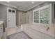 Modern bathroom showcasing a glass-enclosed shower, soaking tub, and natural light at 200 Belted Kingfisher Rd, Kiawah Island, SC 29455