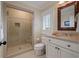 Bathroom showcasing a tiled shower and a white vanity with a stone countertop at 200 Belted Kingfisher Rd, Kiawah Island, SC 29455