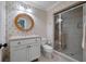 Bathroom featuring palm wallpaper, a glass door shower, and a wood framed mirror at 200 Belted Kingfisher Rd, Kiawah Island, SC 29455