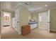 Bedroom featuring a built-in daybed, an attached bathroom, and neutral carpeting at 200 Belted Kingfisher Rd, Kiawah Island, SC 29455
