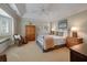 Bedroom with a tray ceiling, a window seat, and a wrought iron bed at 200 Belted Kingfisher Rd, Kiawah Island, SC 29455
