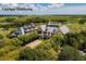 Aerial view of an elegant clubhouse surrounded by lush green landscapes and waterways at 200 Belted Kingfisher Rd, Kiawah Island, SC 29455