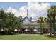Charming outdoor space with green grass and a windmill in the background at 200 Belted Kingfisher Rd, Kiawah Island, SC 29455