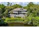 Stately two-story home overlooking a pond, featuring an expansive deck ideal for outdoor entertaining and relaxation at 200 Belted Kingfisher Rd, Kiawah Island, SC 29455