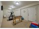 Finished basement game room with tv, foosball table, elliptical machine at 200 Belted Kingfisher Rd, Kiawah Island, SC 29455