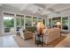 Comfortable living room showcasing large windows with scenic outdoor views and coffered ceilings at 200 Belted Kingfisher Rd, Kiawah Island, SC 29455