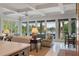 Bright living room with coffered ceilings and large windows showcasing picturesque waterfront views at 200 Belted Kingfisher Rd, Kiawah Island, SC 29455