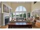 Spacious living room featuring a fireplace and large arched window with a lake view at 200 Belted Kingfisher Rd, Kiawah Island, SC 29455
