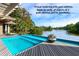 An attractive pool sits right off of a deck overlooking a lake at 200 Belted Kingfisher Rd, Kiawah Island, SC 29455