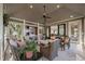 Inviting covered porch with comfortable seating and outdoor kitchen area at 200 Belted Kingfisher Rd, Kiawah Island, SC 29455
