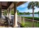 A picturesque porch overlooking a calm lake and lush trees at 200 Belted Kingfisher Rd, Kiawah Island, SC 29455