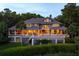 Gorgeous exterior with a large deck perfect for entertaining with lush landscaping and pond views at 200 Belted Kingfisher Rd, Kiawah Island, SC 29455