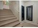 Carpeted staircase with a white railing next to a wine refrigerator at 200 Belted Kingfisher Rd, Kiawah Island, SC 29455