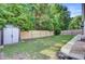 A spacious, fenced backyard features green grass and a convenient storage shed at 2008 Welsh Pony Dr, Mount Pleasant, SC 29429