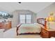 Comfortable bedroom with a large bed, wooden dressers, ceiling fan and bright windows at 2008 Welsh Pony Dr, Mount Pleasant, SC 29429