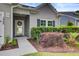 Well-manicured bushes and landscaping highlight the front entryway of this light gray house at 2008 Welsh Pony Dr, Mount Pleasant, SC 29429