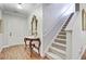 Elegant hallway featuring a decorative mirror, stylish table lamps, and carpeted stairs at 2008 Welsh Pony Dr, Mount Pleasant, SC 29429