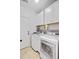 A functional laundry room featuring modern washer and dryer units, with ample storage and a utility sink at 2008 Welsh Pony Dr, Mount Pleasant, SC 29429