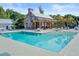 Community pool with a brick pavilion, outdoor seating, and sun loungers, creating a relaxing and inviting recreational space at 2008 Welsh Pony Dr, Mount Pleasant, SC 29429