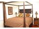 Comfortable bedroom featuring a four-poster bed, stylish lamps, and warm, inviting decor at 204 Michigan Ave B3 # 16, Folly Beach, SC 29439