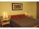 Comfortable bedroom with hardwood floors, warm lighting, and minimalist decor at 204 Michigan Ave B3 # 16, Folly Beach, SC 29439