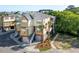 A multi-story home with a two car garage, stairs leading to the main floor, and lovely palm trees at 204 Michigan Ave B3 # 16, Folly Beach, SC 29439