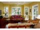 Cozy living room featuring hardwood floors, a ceiling fan, and large windows offering scenic views at 204 Michigan Ave B3 # 16, Folly Beach, SC 29439
