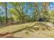 Expansive backyard featuring mature trees, a storage shed, and a tranquil setting perfect for outdoor activities at 205 Owens Dr, Summerville, SC 29485