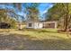 This home has a spacious backyard with mature trees, a fire pit, and shed at 205 Owens Dr, Summerville, SC 29485