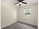 The carpeted bedroom has a ceiling fan and a large window with a backyard view at 205 Owens Dr, Summerville, SC 29485