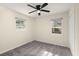 This bright bedroom has two windows, soft carpet, and a ceiling fan at 205 Owens Dr, Summerville, SC 29485