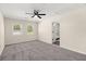 This neutral carpeted bedroom includes a ceiling fan and two bright windows at 205 Owens Dr, Summerville, SC 29485