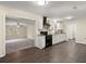 Bright kitchen featuring white cabinets, black appliances, granite countertops, and hardwood floors at 205 Owens Dr, Summerville, SC 29485