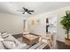 Comfortable living room with hardwood floors, neutral walls, stylish furniture, and seamless flow to the kitchen at 205 Owens Dr, Summerville, SC 29485